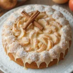 Overhead shot of a creamy apple pie cake with powdered sugar glaze